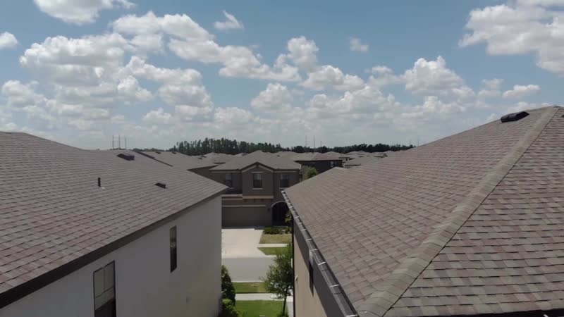 Aerial roof inspection over a Tampa Bay neighborhood